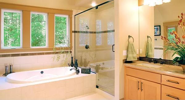 Serene Bathroom with a Garden View and Glass Shower