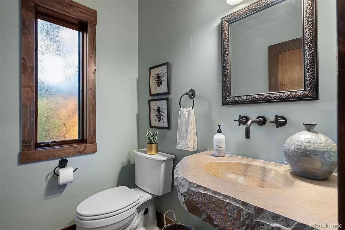 Rustic Powder Room with a Unique Stone Basin