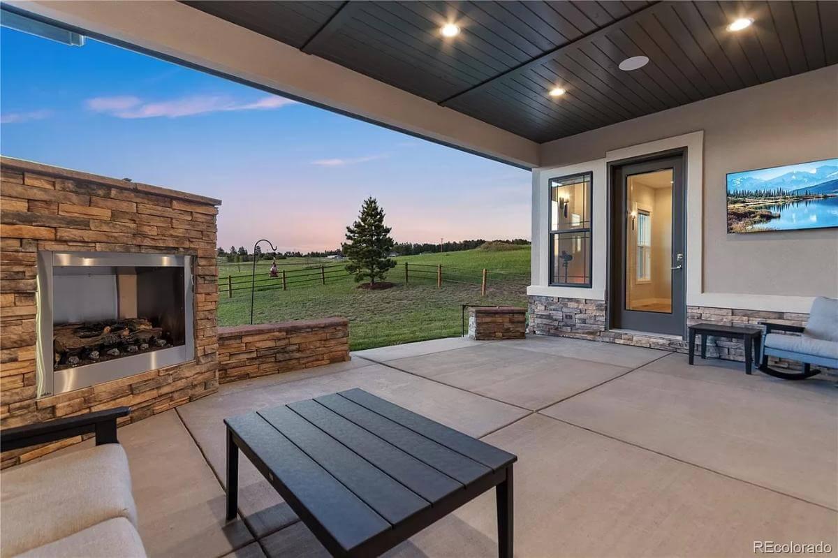 Relax by the Modern Stone Fireplace on This Spacious Patio