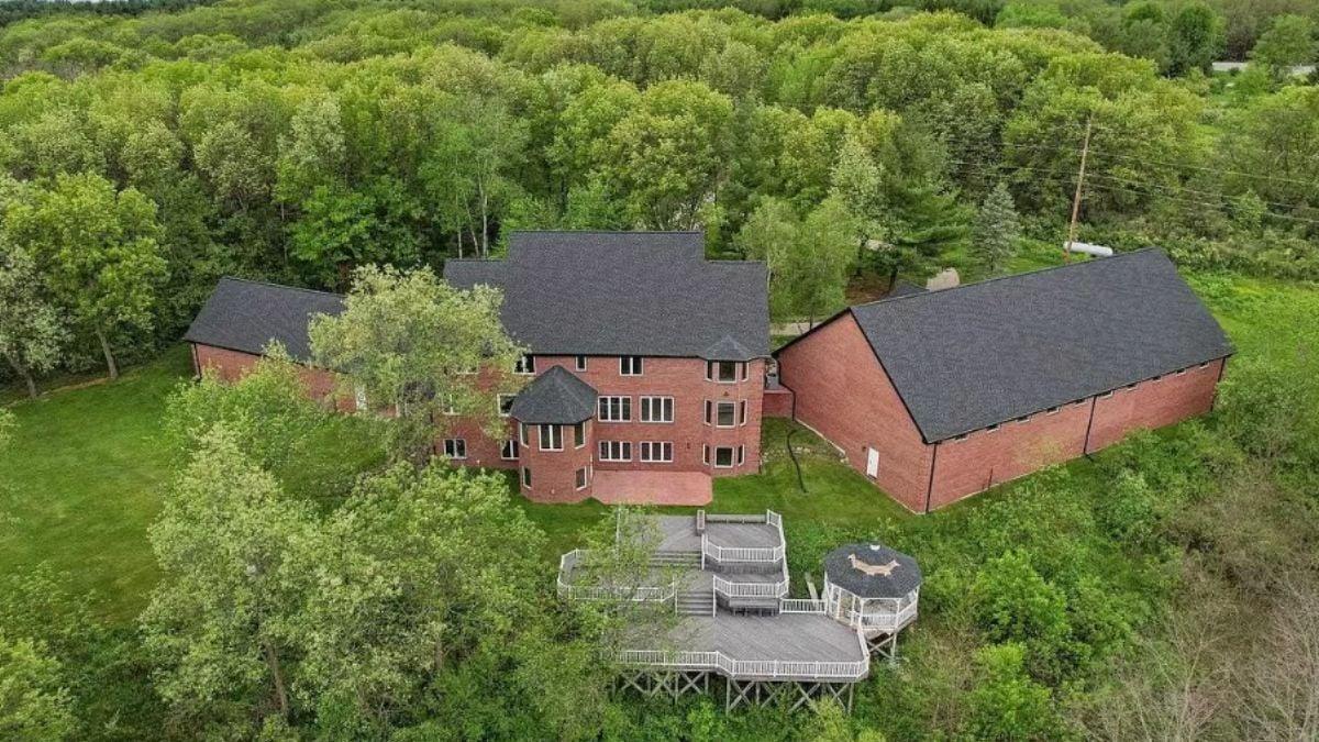 Elegant Brick Mansion with a Tiered Deck Overlooking Woodland
