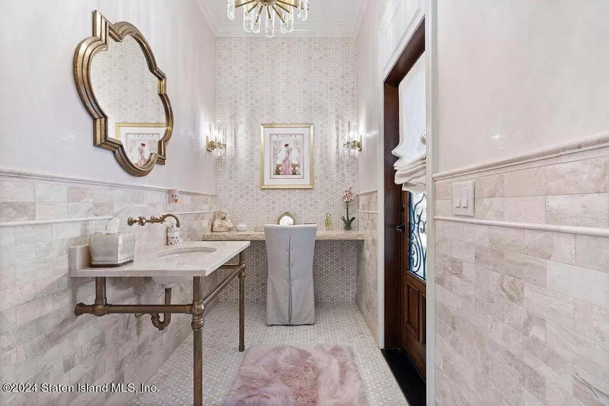 Step Into This Elegant Powder Room with Marble and Brass Accents