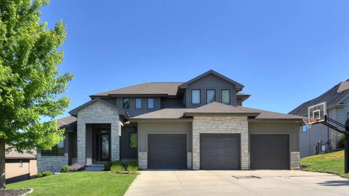 Modern Craftsman Exterior with Stone Detailing and a Triple Garage
