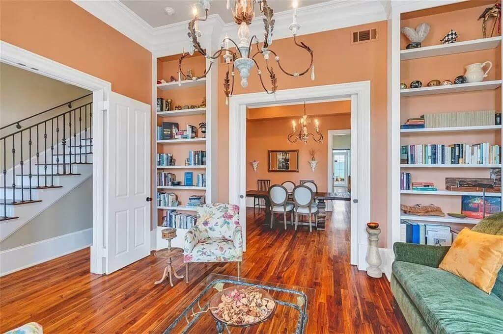 Enjoy the Inviting Sitting Room with Built-In Shelves and a Touch of Elegance