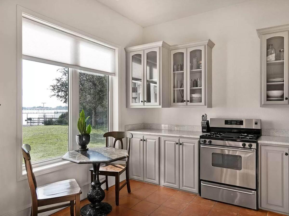 Efficient Kitchen Nook with Lake Views and Glass-Front Cabinets