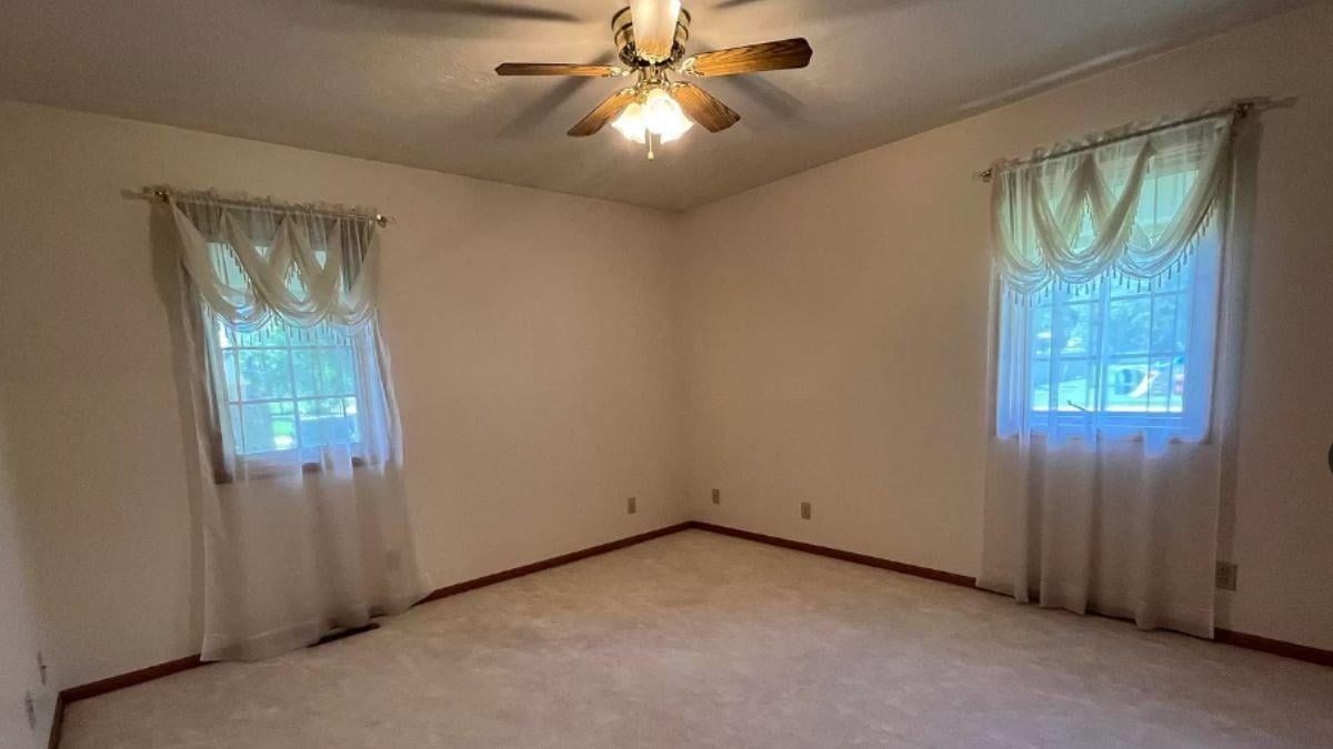 Simple Bedroom with Classic Fan and Window Draperies