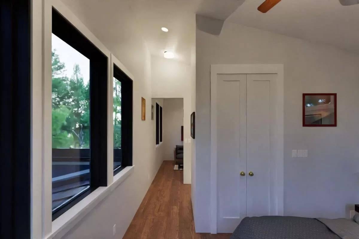 Long Hallway with Modern Touches and Ample Windows