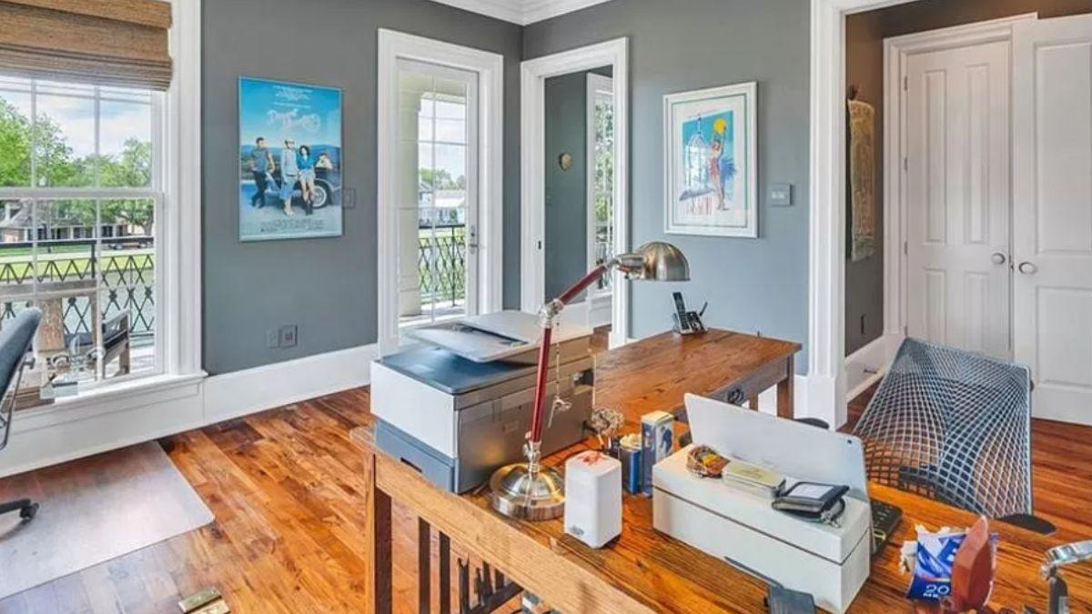 Spot the Sunlit Office with Rustic Desk and Vibrant Art