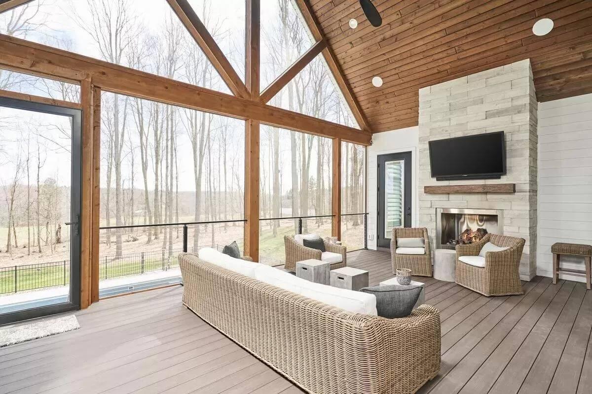 Check Out the Vaulted Wooden Ceiling and Stone Fireplace in This Screened Porch