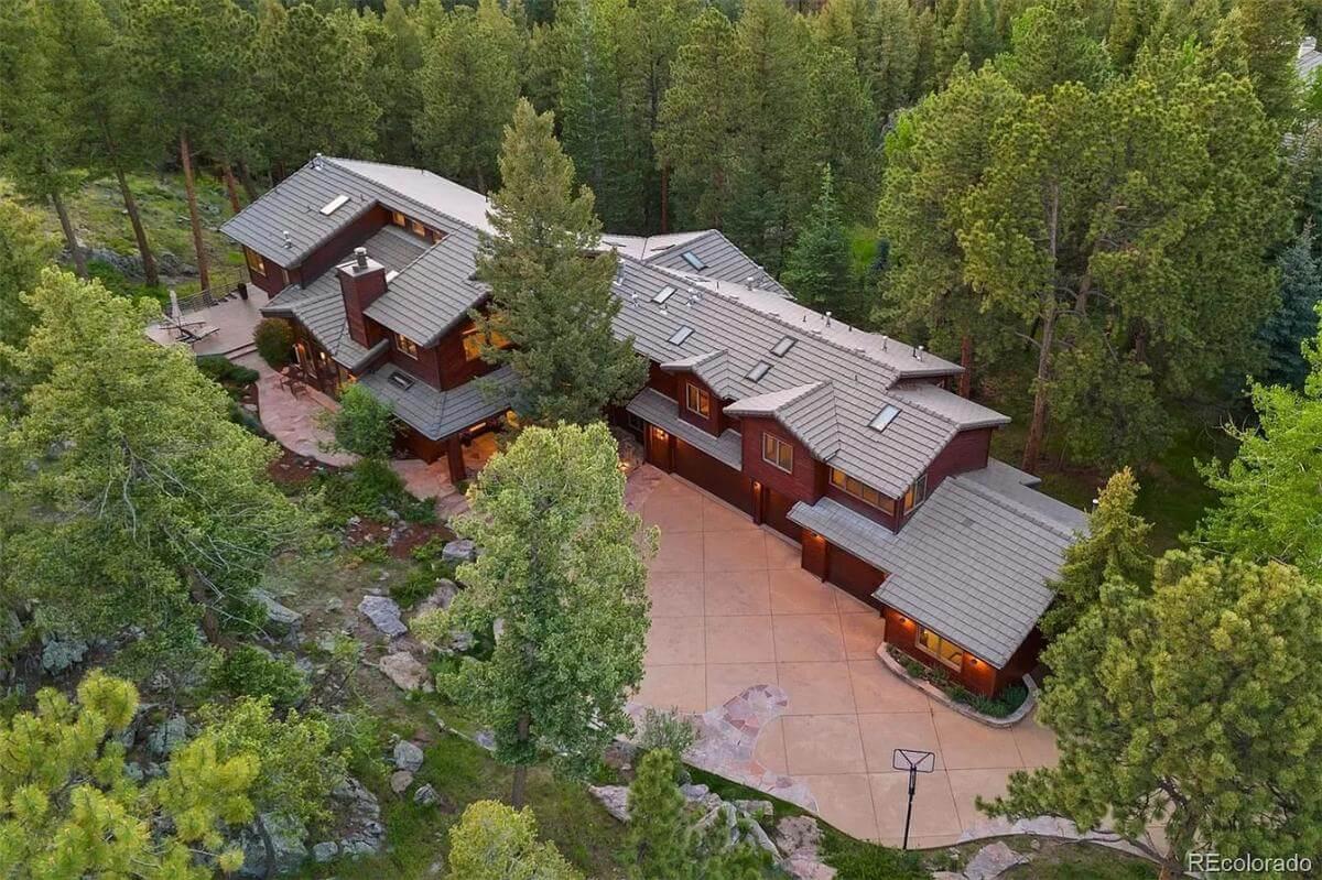 Nestled Forest Home with Dramatic Rooflines and Stone Driveway