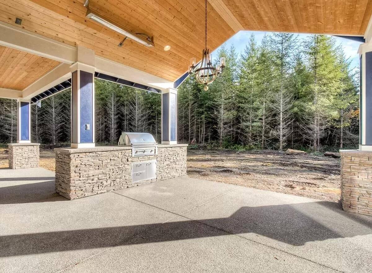 Enjoy the Timber Ceiling and Stone Detailing in This Craftsman Outdoor Kitchen