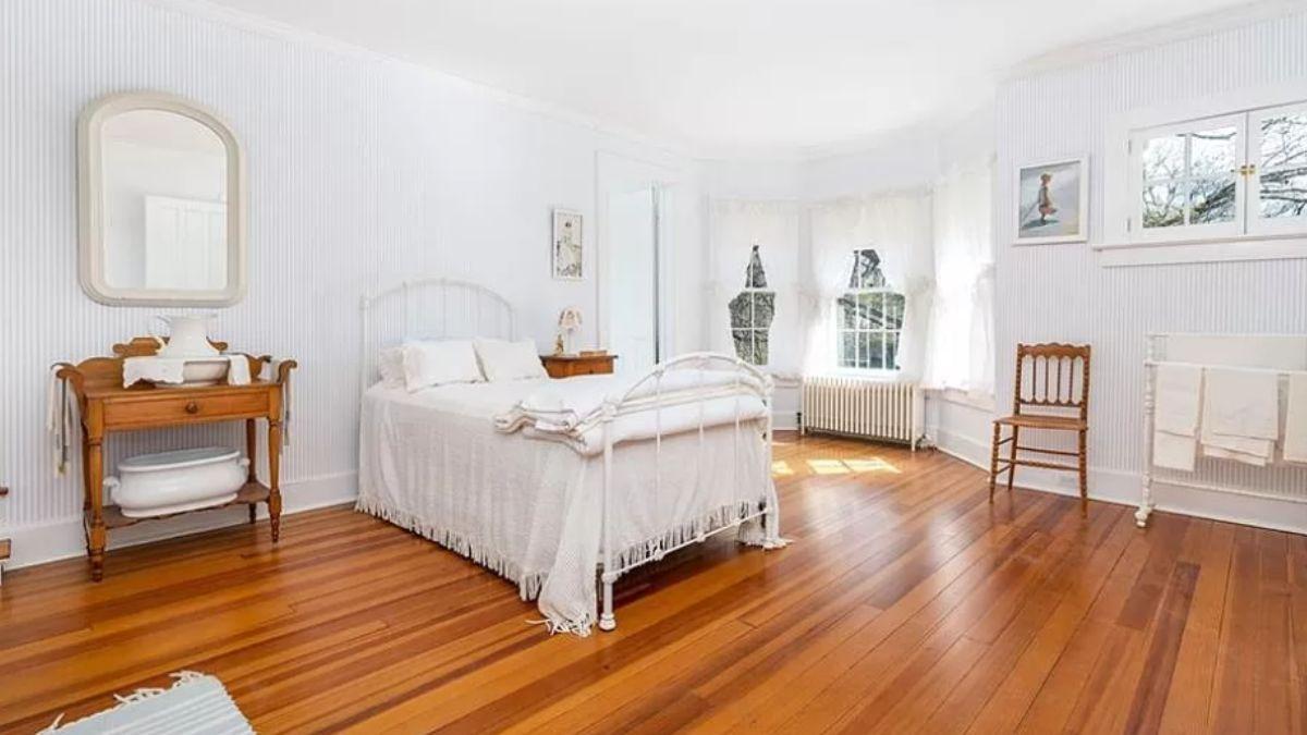Bright Bedroom with Vintage Furniture and Gleaming Hardwood Floors