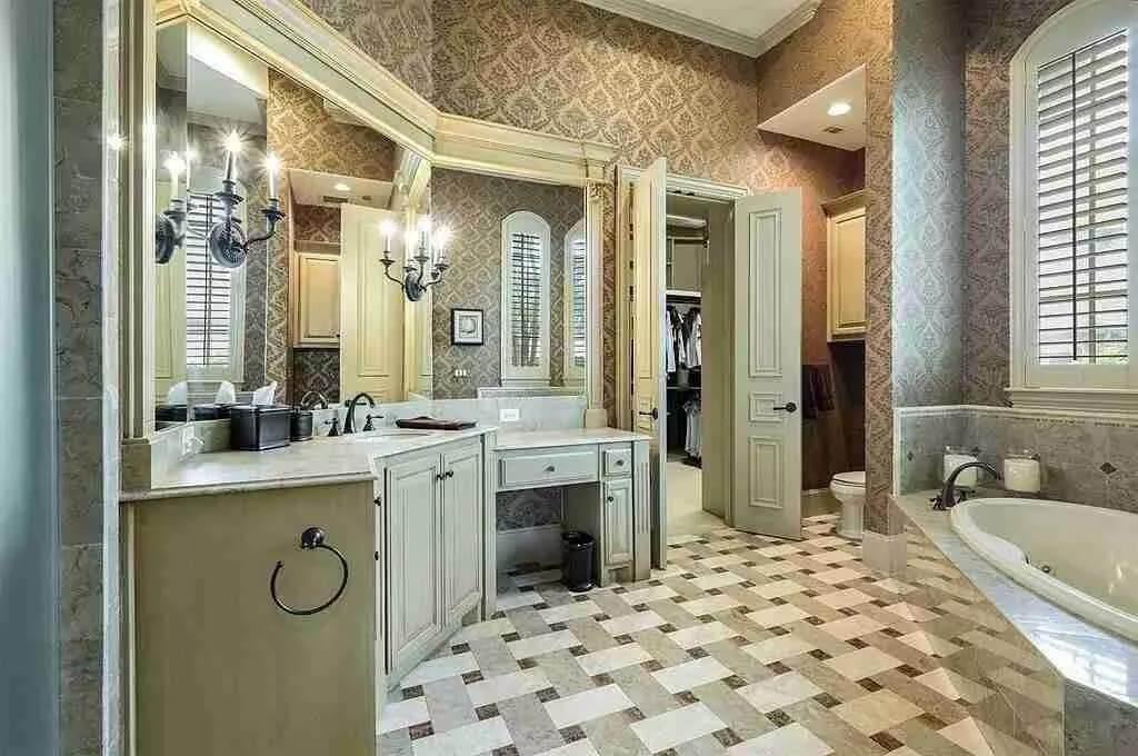 Charming Bathroom with Sophisticated Sconces and Elegant Wallpaper