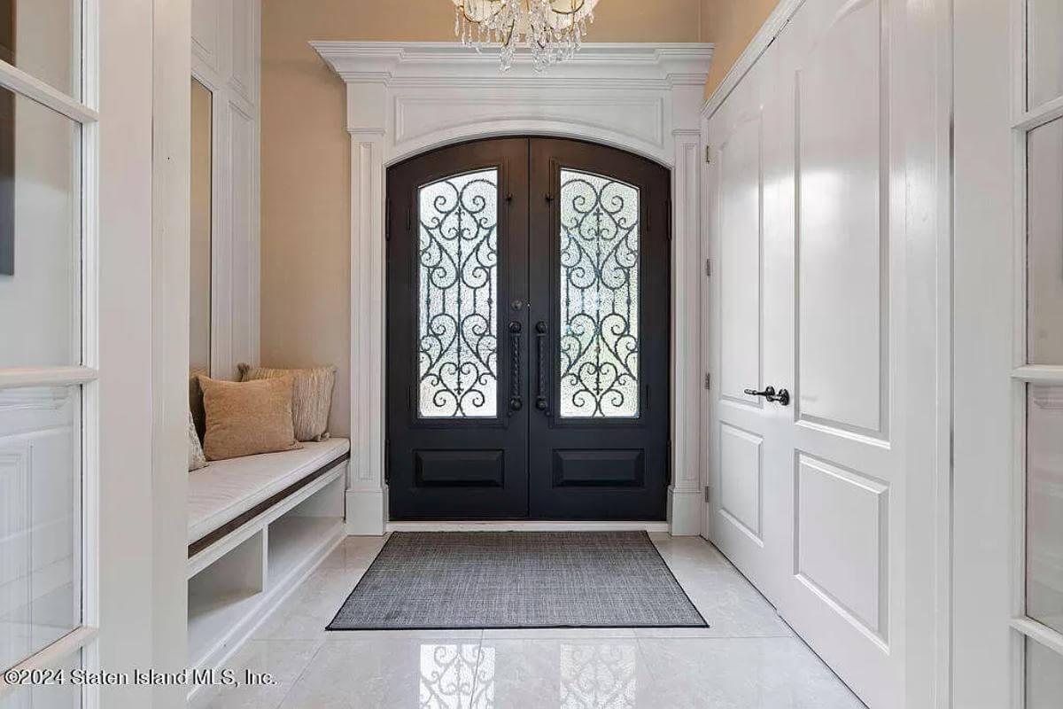 Elegant Entryway with Intricate Iron Detailing on Double Doors