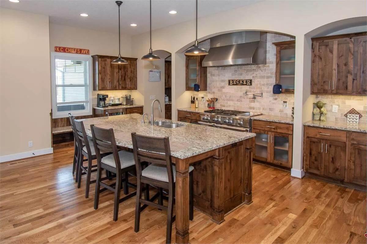 Check Out the Expansive Island and Warm Wood Tones in This Craftsman Kitchen