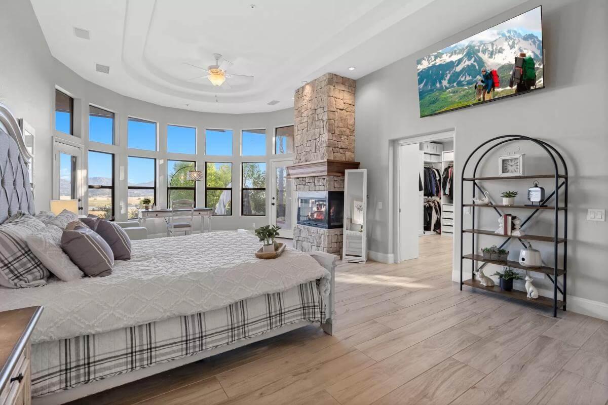 Wow, Check Out the Stunning Stone Fireplace in This Bright Bedroom