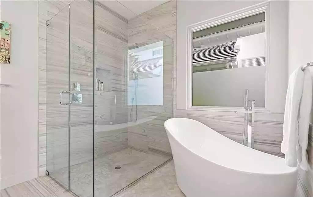 Freestanding Tub and Glass Walk-In Shower in Minimalist Bath
