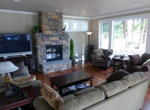 Living Room with Stone Fireplace and Expansive Windows for Natural Light