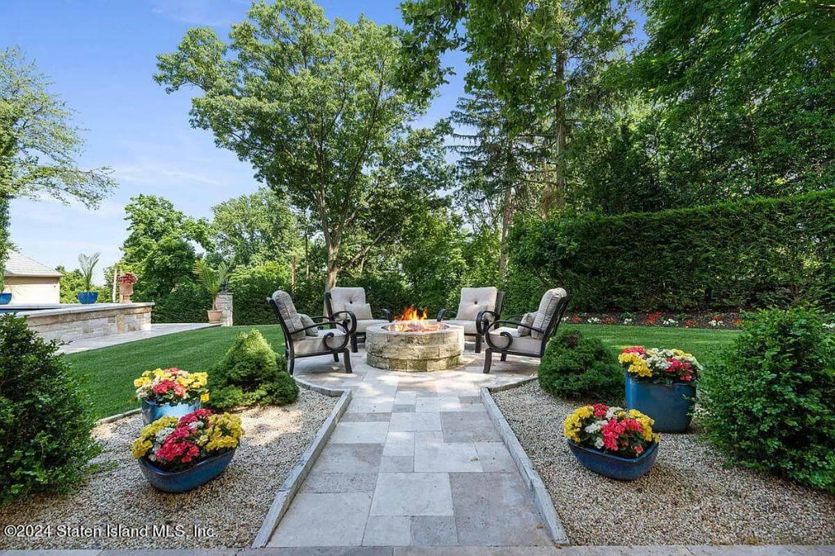 Gather Around the Classic Stone Fire Pit in This Lush Garden