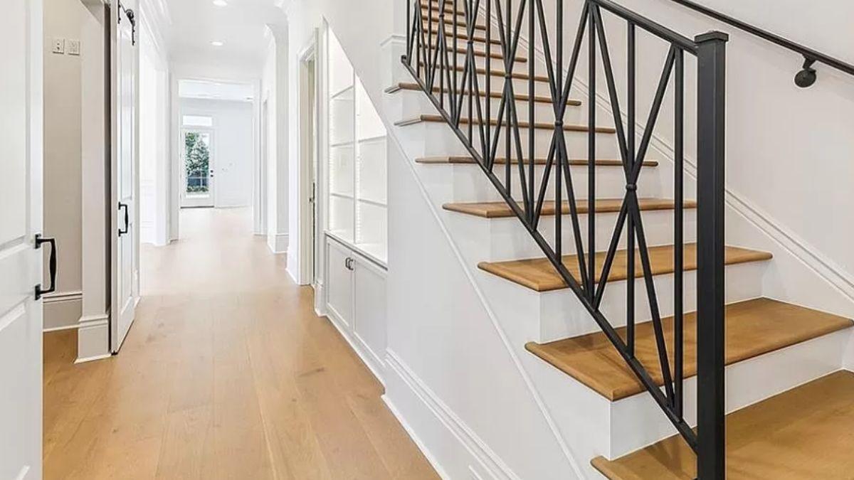 Notice the Unique Iron Staircase Railing in This Inviting Hallway