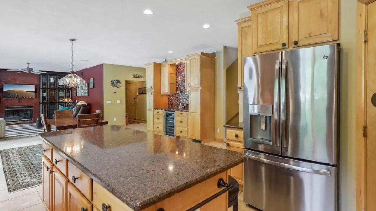 Check Out the Spacious Island and Cozy Living Area in This Craftsman Kitchen