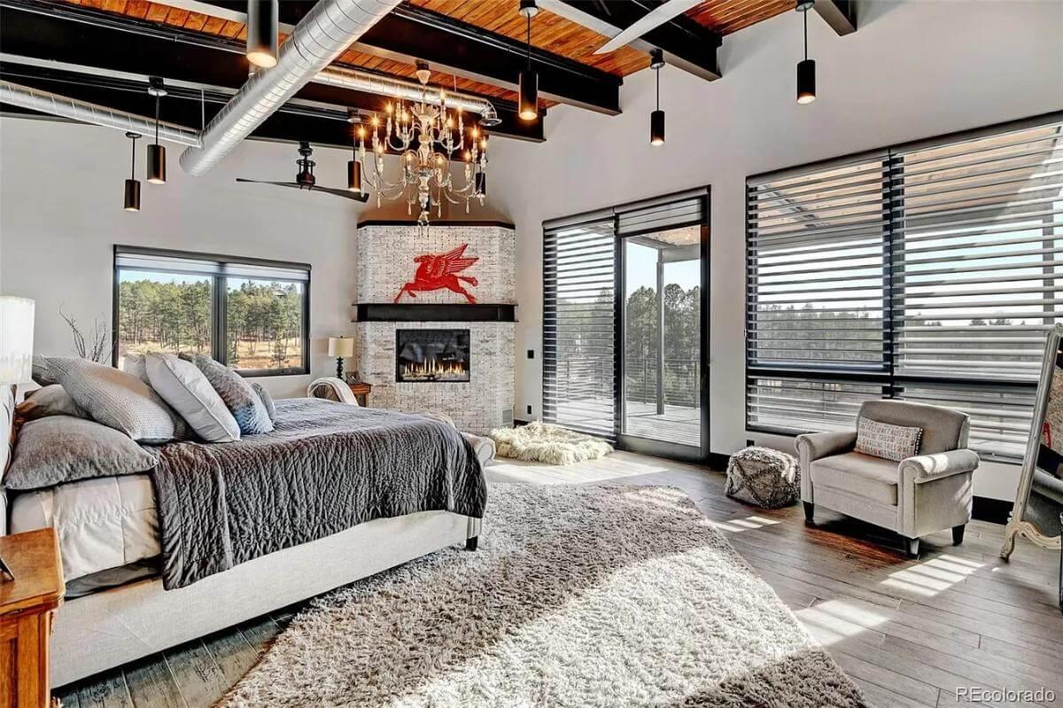 Discover the Industrial Bedroom with a Unique Fireplace Accent