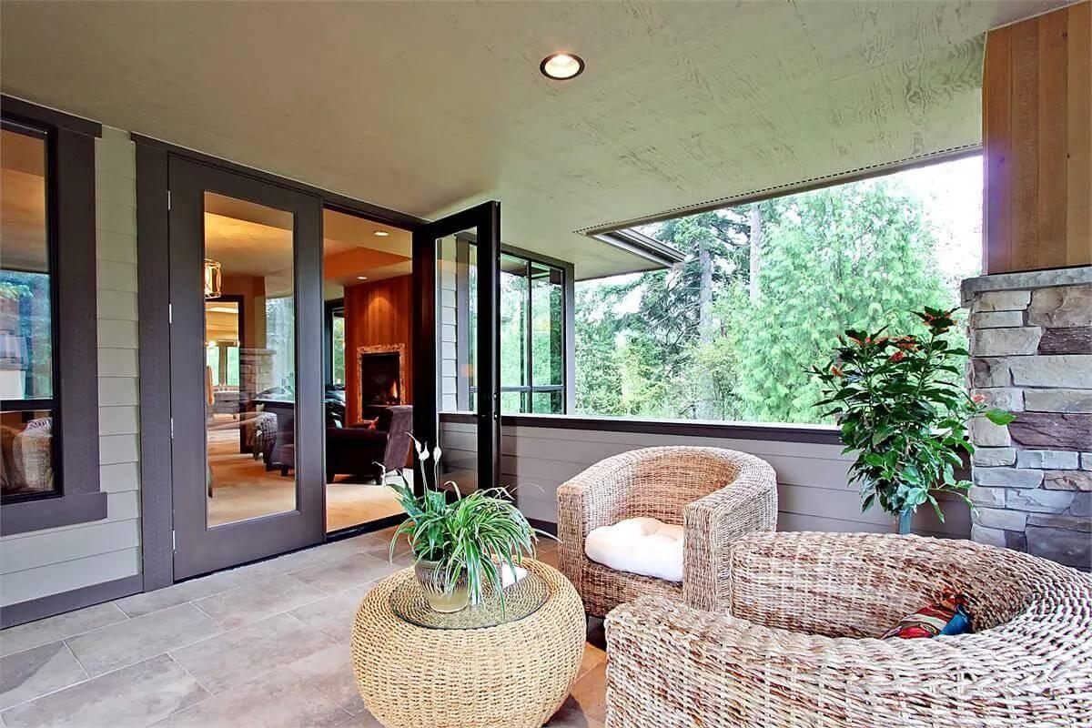 Step into This Craftsman Porch with Wicker Seating and Verdant Views