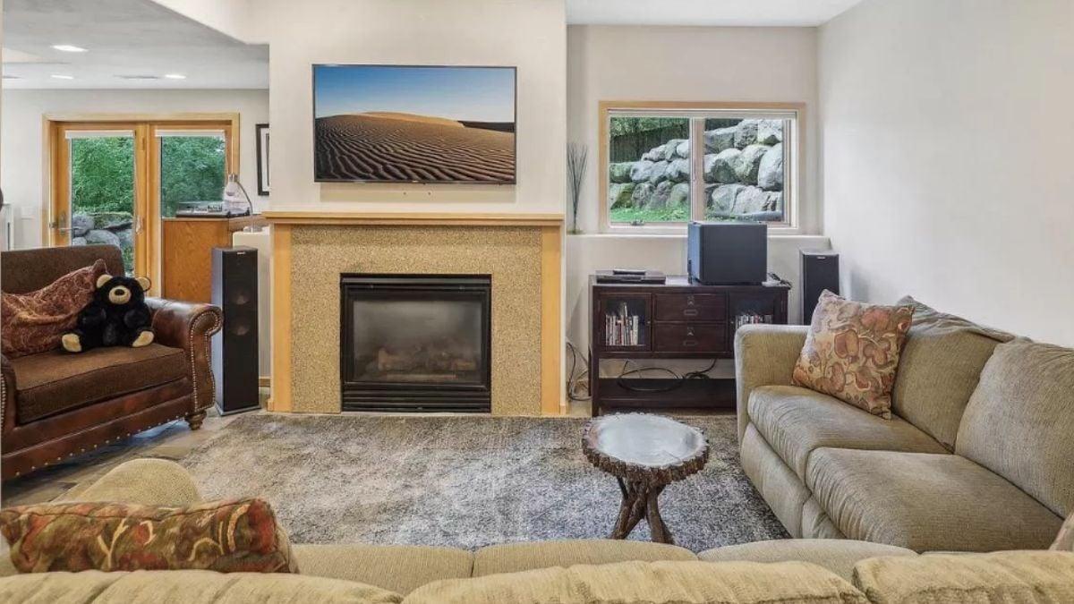 Cozy Living Room with Stone Fireplace and Natural Views