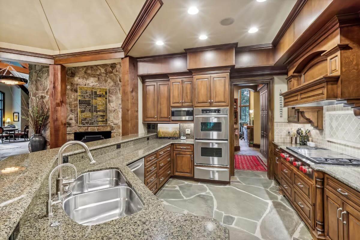 Gourmet Kitchen Elegance with Stone Accents and Dual Ovens