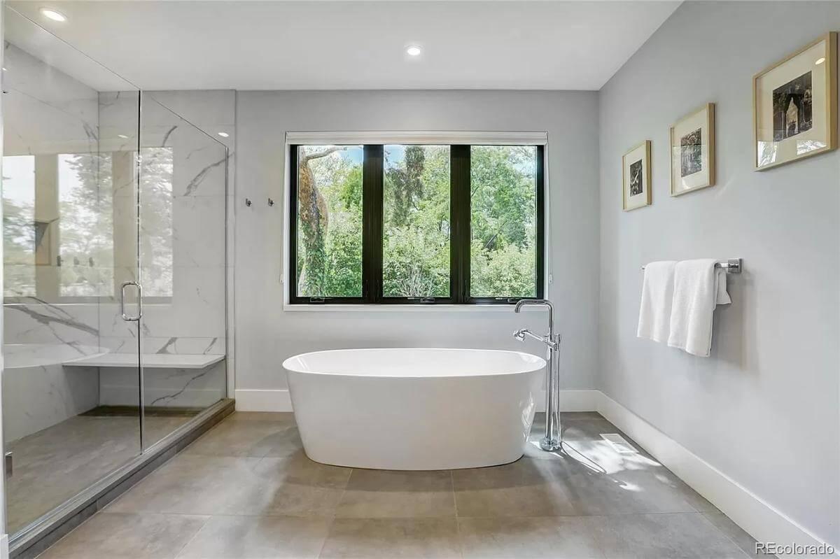 Admire the Freestanding Tub and Expansive Glass Shower in This Luxurious Bathroom