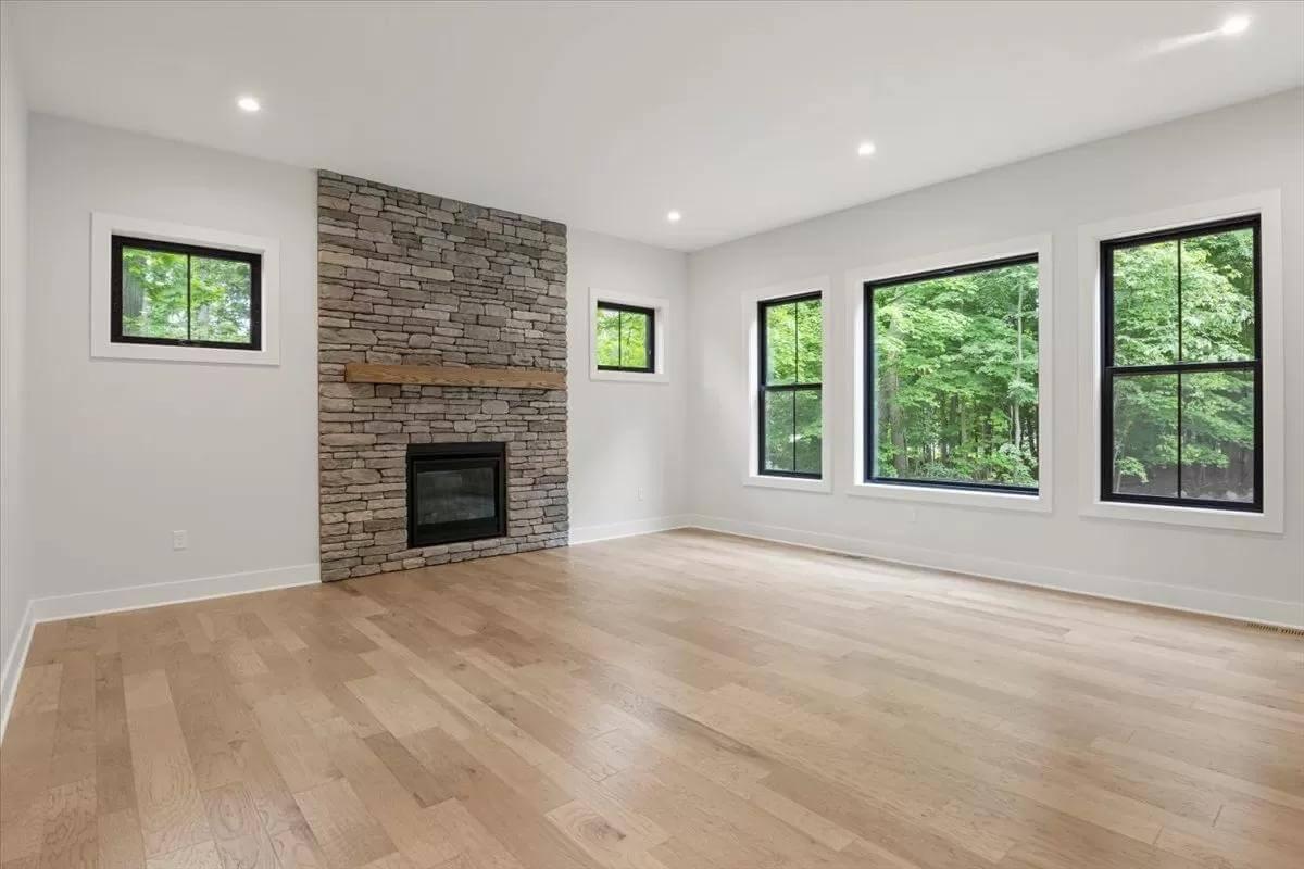 Stone Fireplace Anchors an Open and Bright Living Area