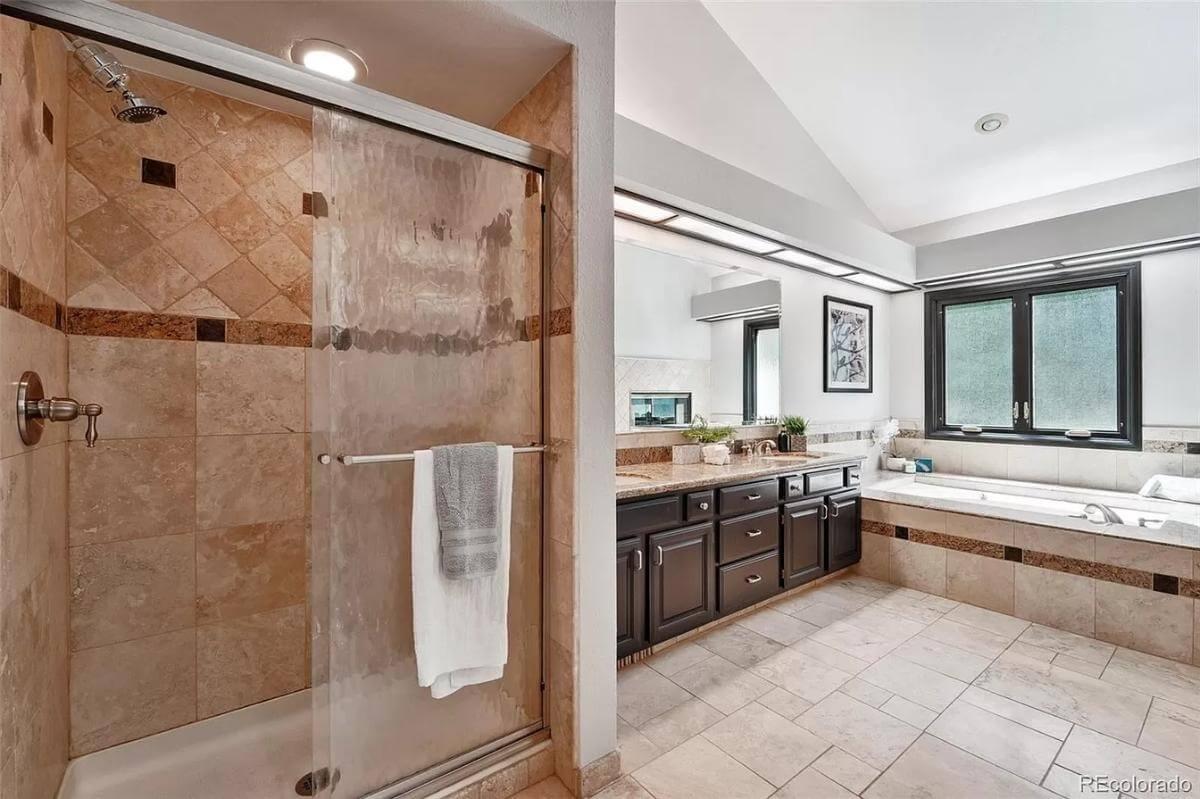 Sleek Bathroom with Luxurious Tiled Shower and Generous Vanity