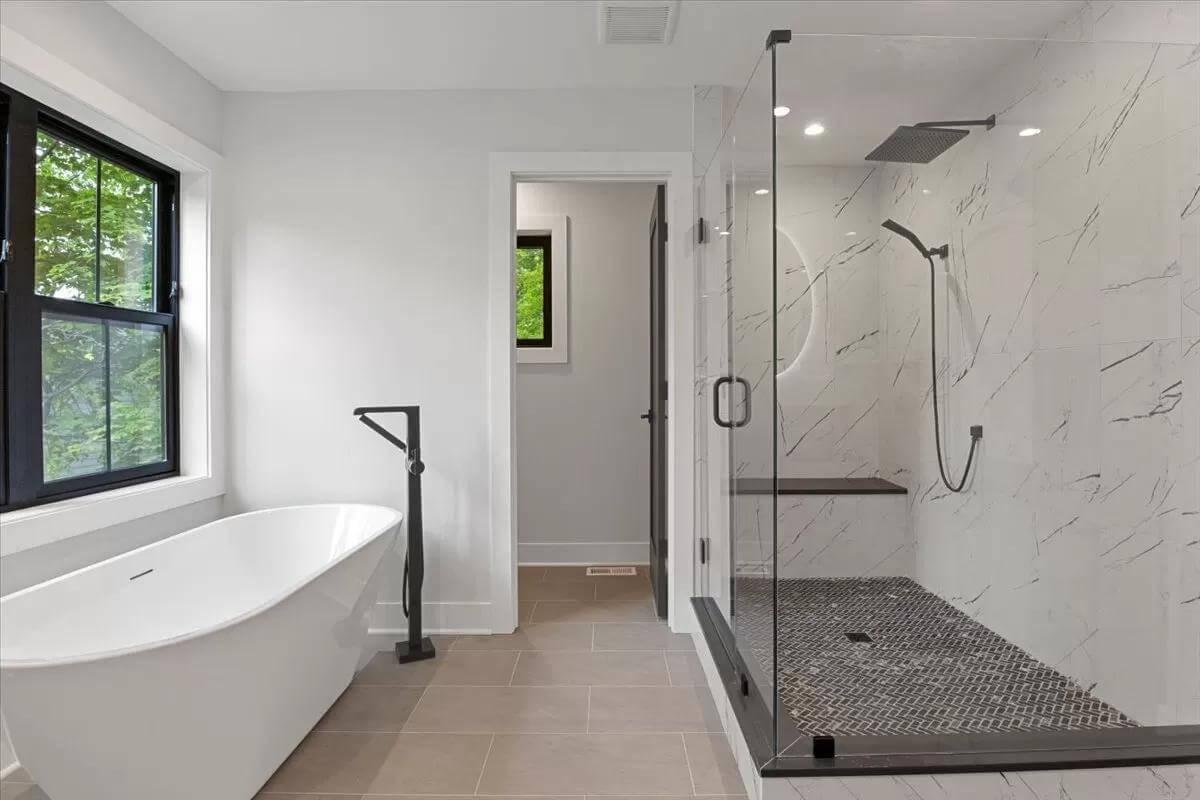 Freestanding Tub and Seamless Glass Shower Define This Clean Bath