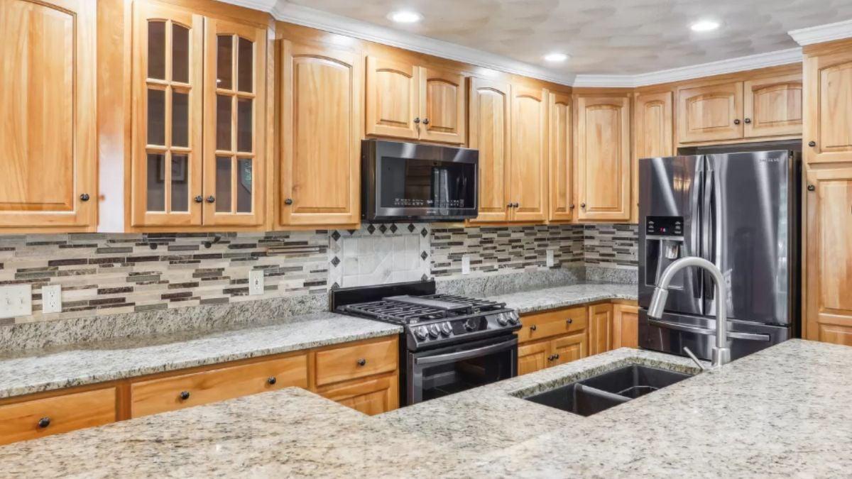 Notice the Textured Mosaic Backsplash in This Classic Kitchen