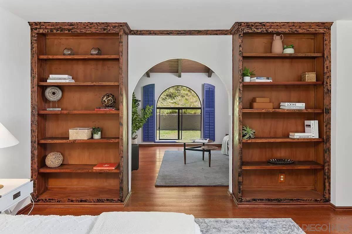 Check Out the Bold Blue Shutters Paired with Classic Wooden Shelving