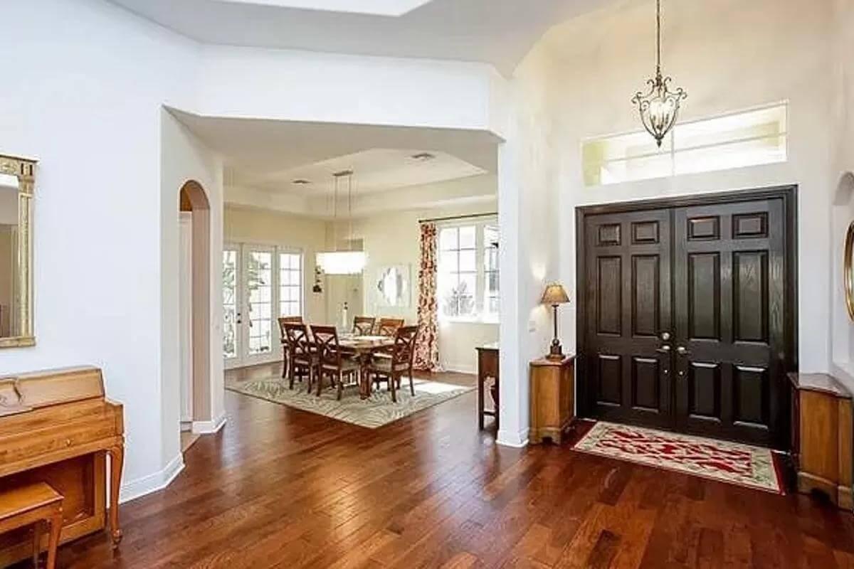 Welcoming Foyer Leads to Open Dining with French Doors