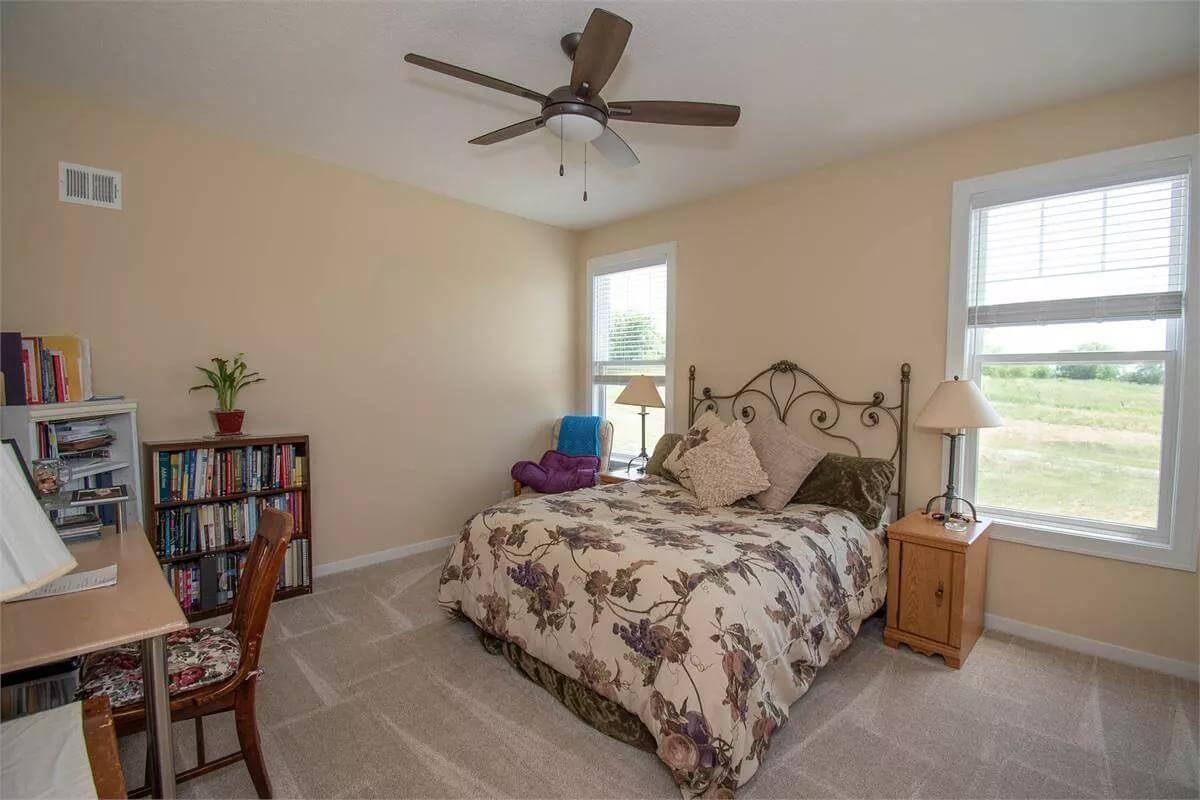 Cozy Bedroom with Wrought Iron Headboard and Ample Natural Light