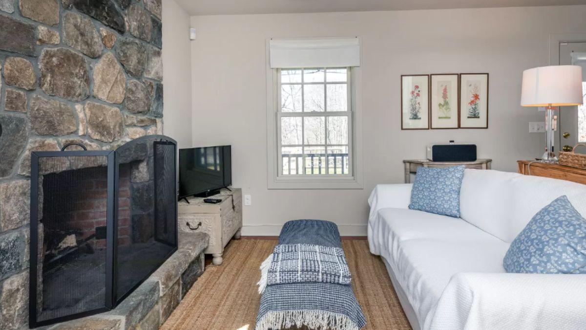 Enjoy This Cozy Living Room with a Rustic Stone Fireplace