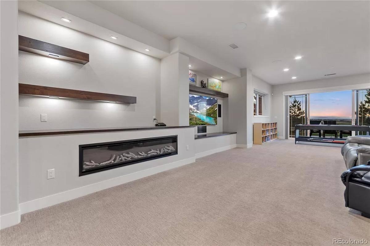 Explore the Contemporary Fireplace in This Spacious Media Room