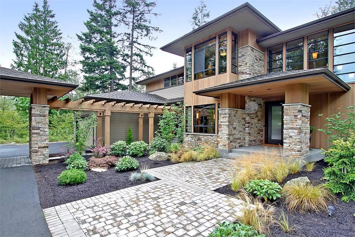 Striking Craftsman Exterior with Stone Columns and a Modern Pergola