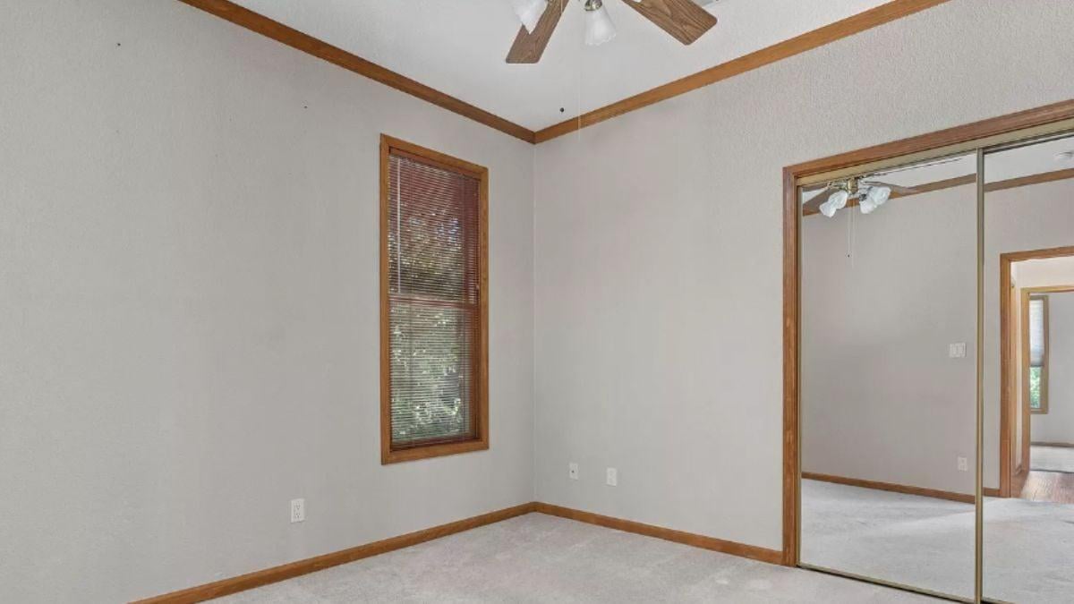Neutral Room with Mirrored Closet and Wood Trim