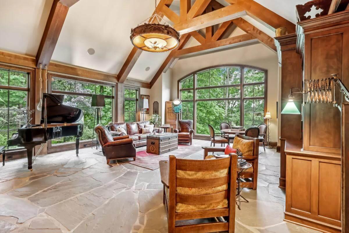 Expansive Living Room with Vaulted Timber Beams and Cozy Fireplace
