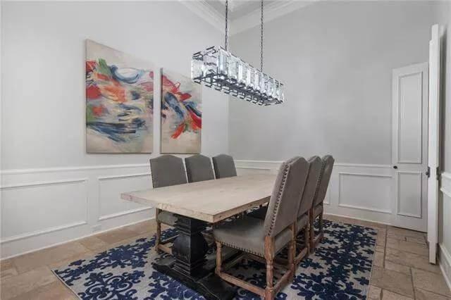 Contemporary Dining Room with Vibrant Art and a Unique Chandelier