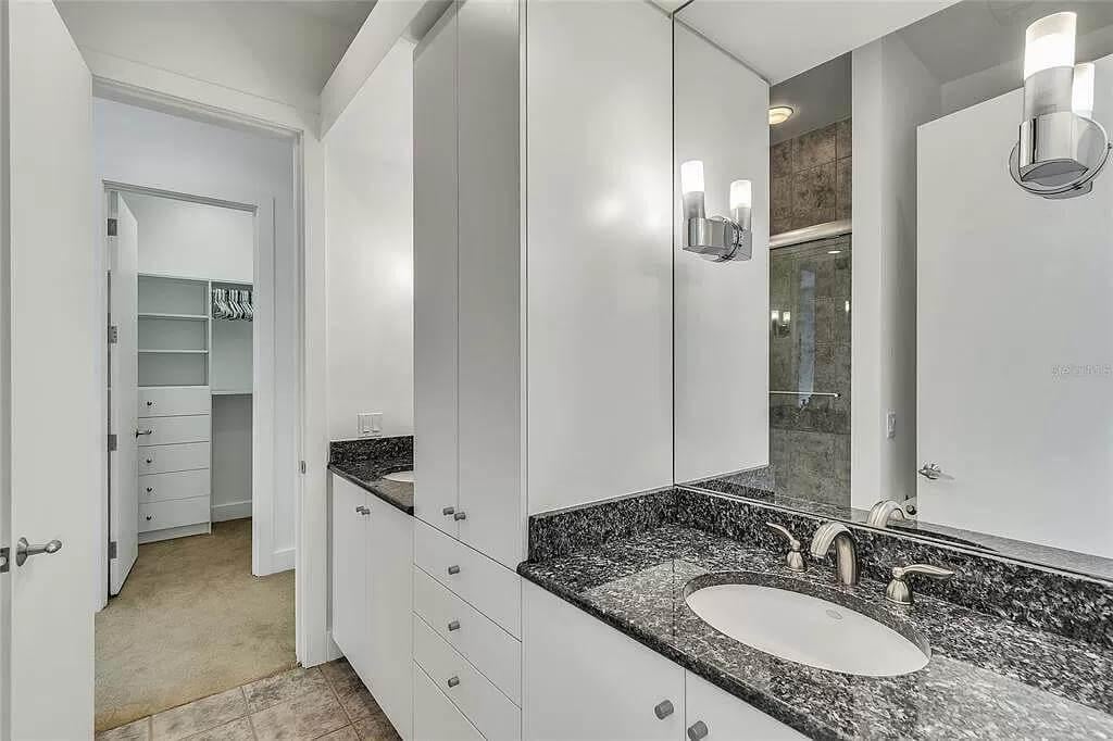 Sleek Bathroom with Granite Countertops and Ample Storage
