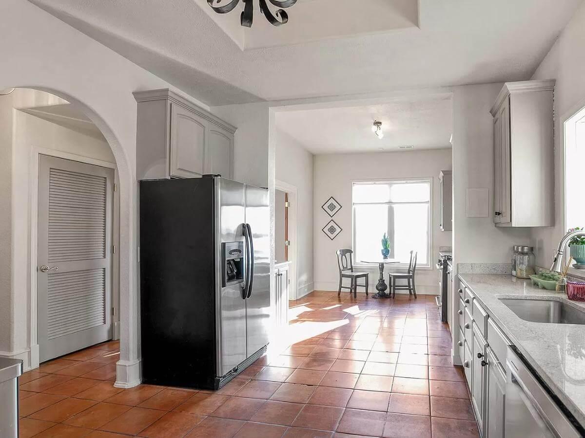 Functional Kitchen with Terracotta Floors and Cozy Breakfast Nook