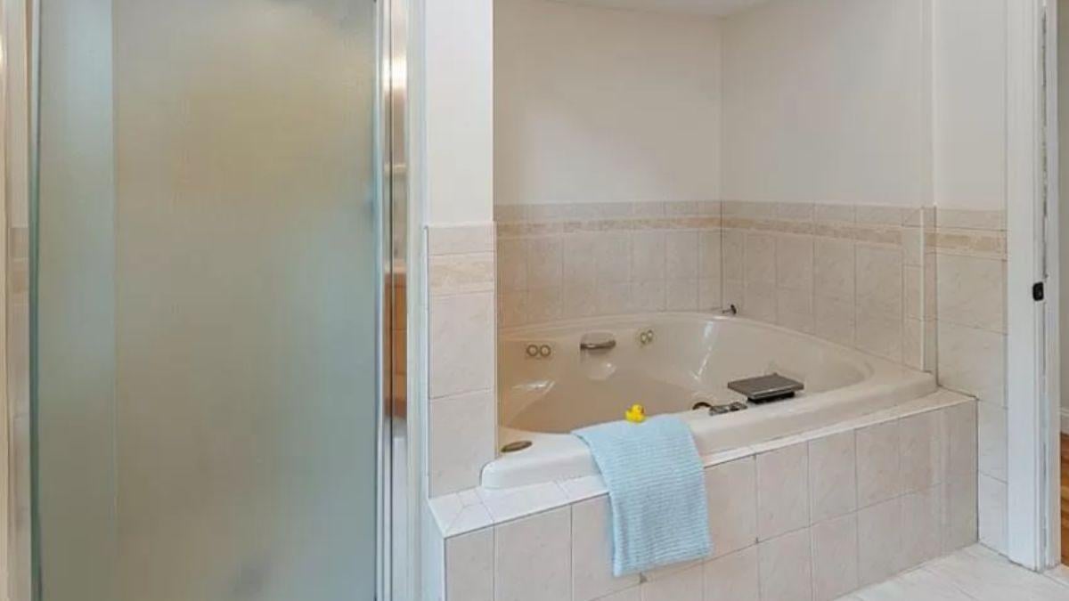 Relax in This Craftsman Bathroom Featuring a Corner Jetted Tub