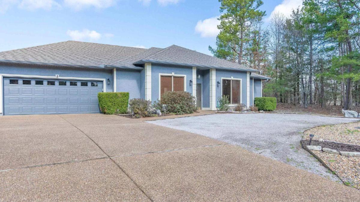 Clean and Quiet: Gravel Driveway Meets Muted Blue Facade