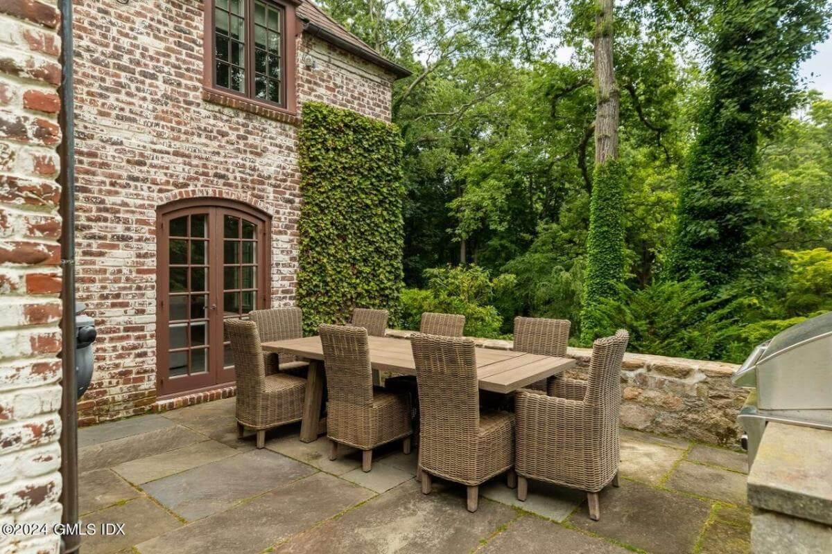 Enjoy Alfresco Dining with a Woodland Backdrop on This Patio