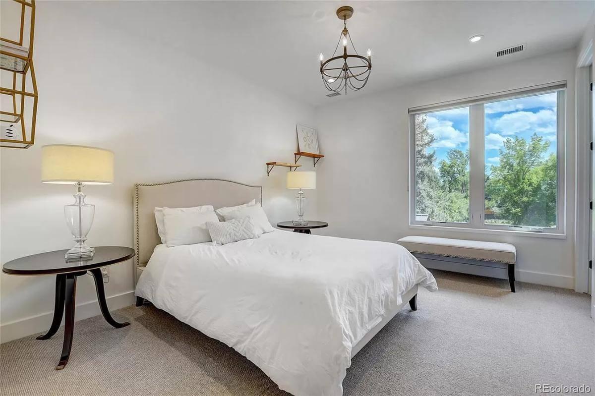 Notice the Elegant Chandelier and Minimalist Design in This Bedroom Retreat