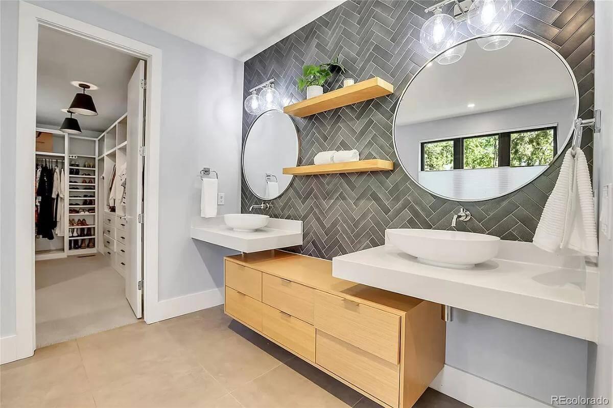 Sleek Bathroom Design Featuring Herringbone Tile and Dual Vanities