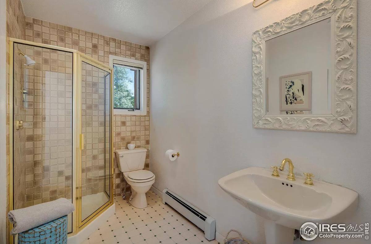 Notice the Vintage Brass Fixtures in This Compact Bathroom